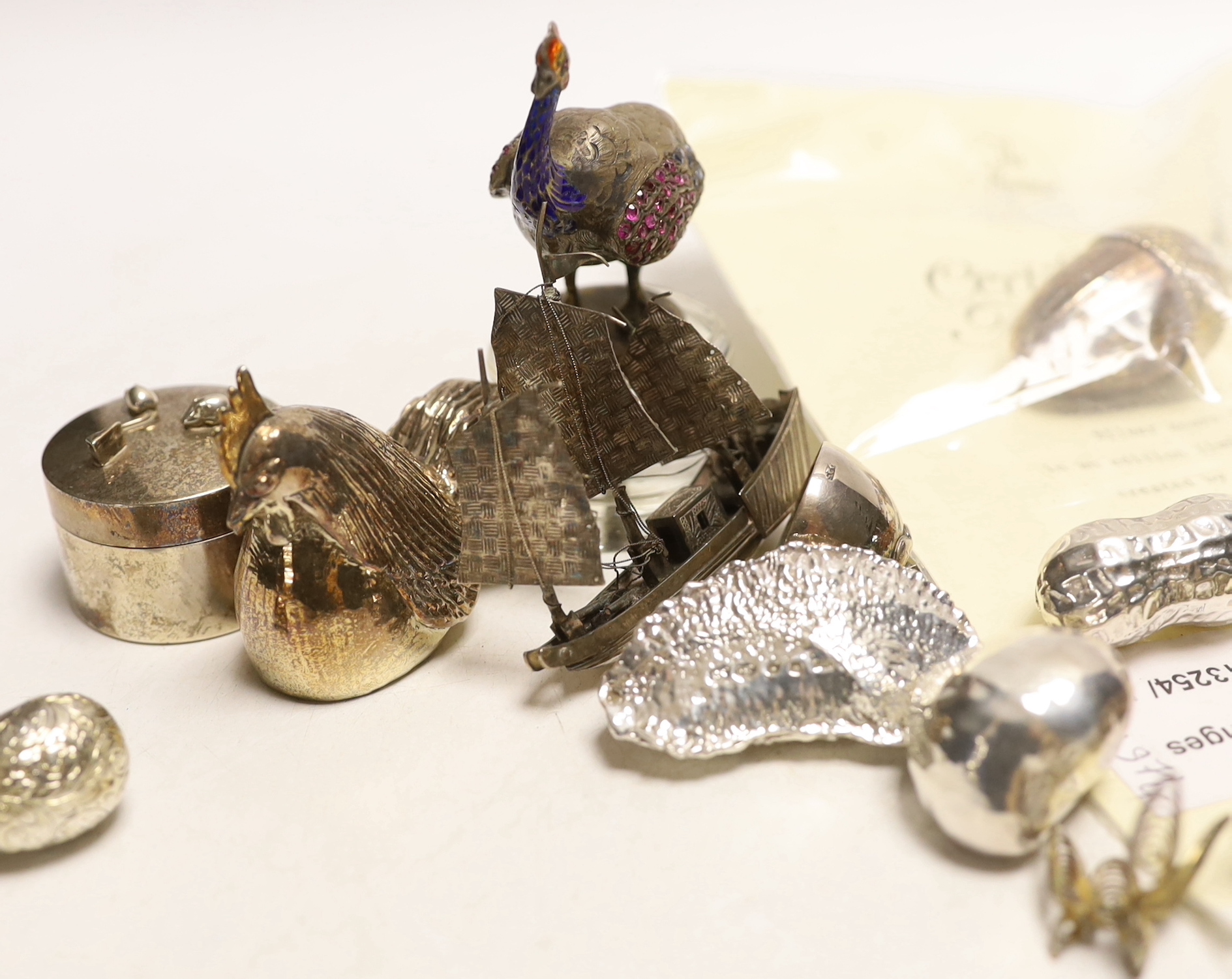 A group of modern novelty silver and white metal items including a limited edition surprise acorn by Christopher Nigel Lawrence, London, 1983, opening to reveal two squirrels, 43mm, with certificate, four novelty silver